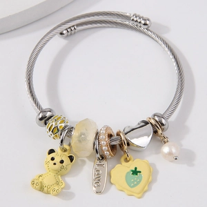 Stainless steel cable bracelet with yellow bear charm, heart pendant and pearls