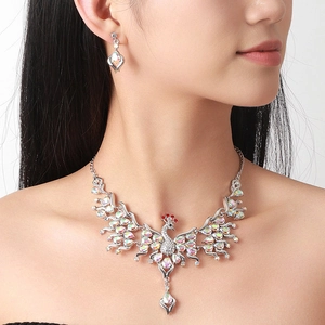 Sparkling peacock jewelry set with crystal necklace and matching earrings on a female model