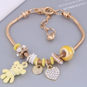 Golden snake chain charm bracelet with matte bear, heart pendant and pearls for women