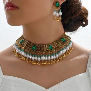 Bohemian jewelry set with green gemstone necklace and pearl tassel earrings on model