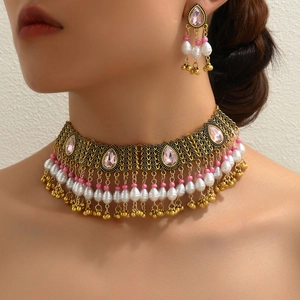 Bohemian ethnic jewelry set with pink crystals and pearls shown on a model