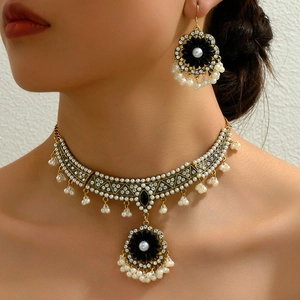 Vintage gold rose jewelry set with pearls and rhinestones worn by a model