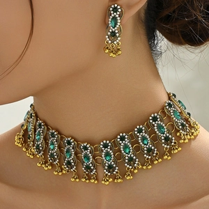 Vintage gold jewelry set with emerald green crystals and white diamond accents for women