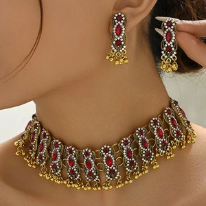 Bohemian gold necklace and earring set with red gemstones and tassel fringe detail