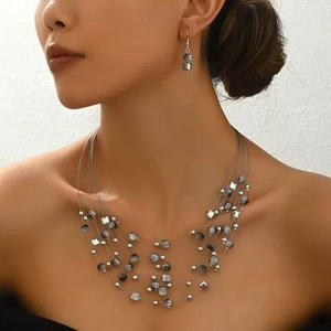 Bohemian multi-layer gray crystal bead necklace and earring set on model for elegant look