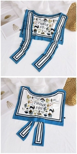 Detail of silk scarf with cartoon girl print and Thank You text on blue border