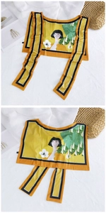 Detailed view of yellow ice silk shawl with artistic female portrait and leaf patterns
