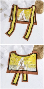 Detail of thin silk scarf showing a girl and polar bear illustration in yellow flower field