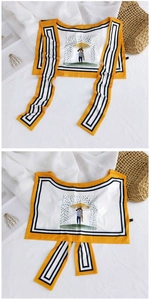 Detail view of yellow ice silk sun protection shawl with cartoon print and striped borders