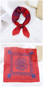 Detail of red square cotton scarf with Beatles inspired print and star patterns