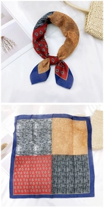 Detail of multi-color patterned cotton linen scarf with red paisley design and blue borders