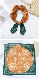 Detail of square cotton linen scarf with green and orange skull pattern textures