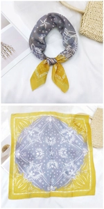 Detail of square cotton linen scarf with star and wing pattern in yellow and grey-blue