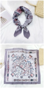 Detailed view of square silk scarf with purple artistic floral and bird prints