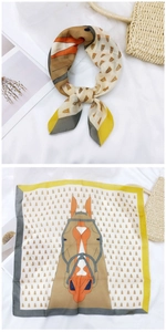 Detail showing horse head print square scarf with silk texture and equestrian patterns