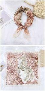 Detail of vintage map print silk scarf with seahorse design and nautical crown crest