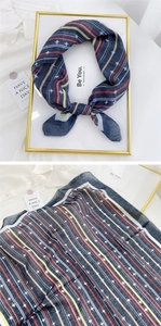 Detail of navy blue cotton linen scarf with star prints and multi-color stripes