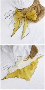 Detail of yellow mesh scarf with black scalloped edge for hair and neck styling