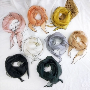 Rhombus mesh scarf in eight colors displayed on a white background with props