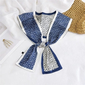 Detail of navy blue geometric pattern silk scarf with professional hem and care label