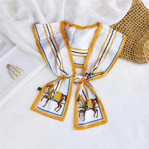 Macro detail of yellow and white twilly scarf with horse print on woven basket