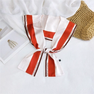 Detailed view of red and white striped silk scarf with Fashion Studio printed edge