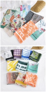 Close-up of assorted cotton linen scarves with diverse floral and geometric patterns