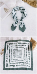 Detail of green cotton linen square scarf with L.David pattern and rolled edges