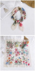 Detailed flat lay of a floral cotton linen scarf with vintage pattern and knot style