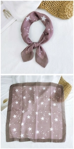 Detail of pink cotton linen square scarf with white moon and star patterns and brown edges