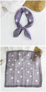 Close-up of purple square scarf with white star and moon prints in soft fabric