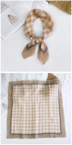 Detail of a brown and beige checkered cotton linen scarf with elegant dark grey borders