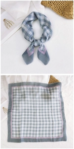 Detail of square cotton linen scarf with green plaid pattern and pink borders
