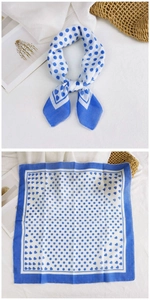 Close-up of blue and white polka dot cotton linen neckerchief with heart patterns