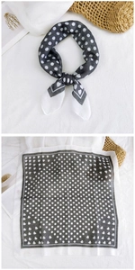 Detail of square cotton linen scarf featuring black polka dots and heart patterns on white