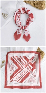 Detail view of red and white cotton linen square scarf featuring geometric line prints