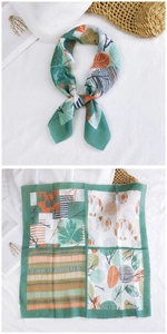 Detail of green floral cotton linen neck scarf with botanical leaves and geometric patterns