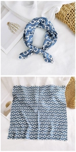 Detail of blue square silk scarf with white chain print and delicate stitched edges