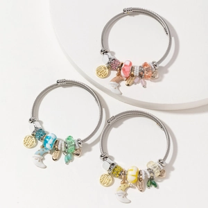 Three open stainless steel bangles with moon charms, crystals and pearls in varied colors