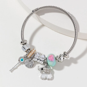 Silver charm bracelet with key, elephant, and crystal beads on twisted rope chain