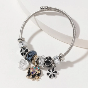Silver tree of life wire bangle with elephant charms and colorful beads on white background