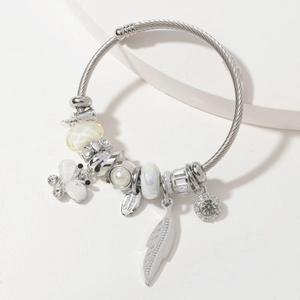 Silver twisted open bangle with butterfly and pearl charms in a minimalist style
