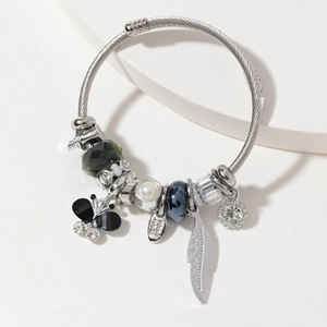 Silver steel cable bangle with butterfly charm, white pearls and blue crystal beads