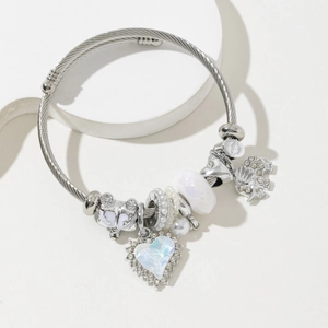 Silver stainless steel beaded bracelet featuring heart and elephant charms on stone pedestal