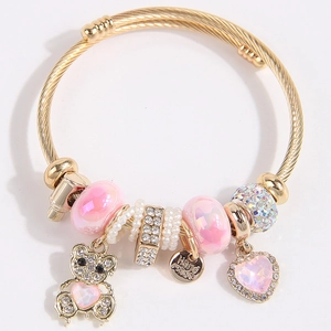 Golden DIY bangle with pink charms, pearl beads, and a sparkling bear pendant charm