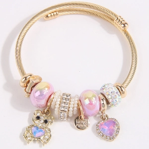 Gold braided stainless steel bracelet with teddy bear charm and pink heart beads