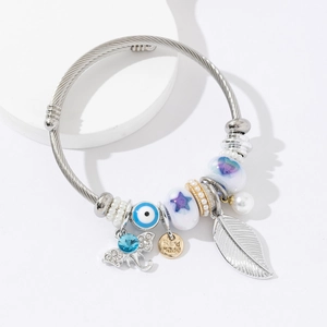 Adjustable stainless steel bangle with elephant, evil eye, and feather charms for women