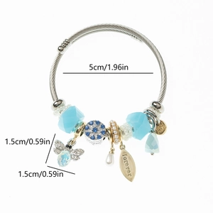 Detail view of steel beaded bracelet with blue crystals and forever bee charm