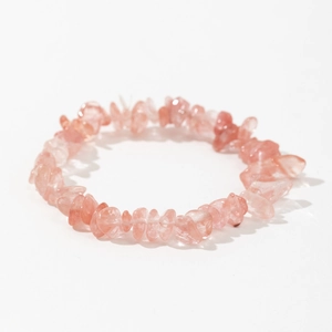 Macro shot of irregular pink natural strawberry quartz stone stretch bracelet beads