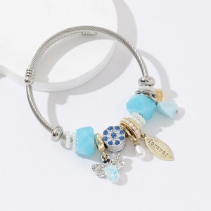 Silver twisted wire bracelet with blue beads, honey bee charm, and gold forever leaf